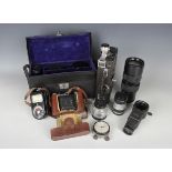 A collection of assorted cameras and accessories, including a Zeiss Ikon Contaflex, a Kodak 'Model