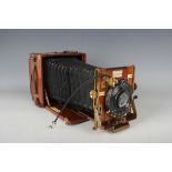An early 20th century mahogany and gilt brass cased folding plate camera, 'The Sanderson', with