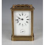 An early 20th century French lacquered brass carriage alarm clock with eight day movement striking