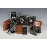A collection of twenty-seven folding cameras, including two Zeiss Ikon Super Ikonta 532/16 cameras