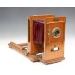 A late 19th century Westminster Photographic Exchange mahogany and gilt brass enlarger with red