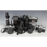 A collection of 35mm cameras and lenses, including Nikon FG-20 with Zoom-Nikkor 35-70mm lens,