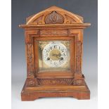 A late 19th century German walnut mantel clock with Junghans eight day movement striking on a