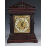 A late 19th century German oak mantel clock with eight day movement striking on two gongs, the