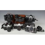 A collection of 35mm cameras, including Nikon F90X with Nikkor 35-70mm lens, Mamiya MSX 500 with