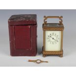 An early 20th century brass cased carriage timepiece with eight day movement, the cream enamelled