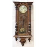 A late 19th century walnut Vienna style wall clock with eight day movement striking on a gong, the
