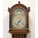 A 20th century Dutch oak cased wall clock with weight driven movement, the painted breakarch dial