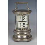 A mid-20th century nickel-plated cylindrical glazed ticket clock with thirty hour spring driven