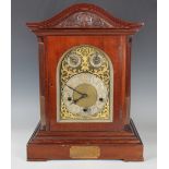 An early 20th century mahogany bracket clock with three train eight day movement chiming quarters on