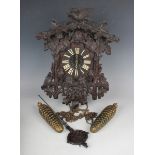 A late 19th century Black Forest carved oak cuckoo wall clock by Fürderer Jaegler, the weight driven