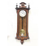 A late 19th century walnut and ebonized Vienna style wall clock with eight day movement striking