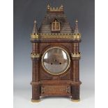 A late 19th century Continental brass mounted carved walnut mantel clock with eight day movement