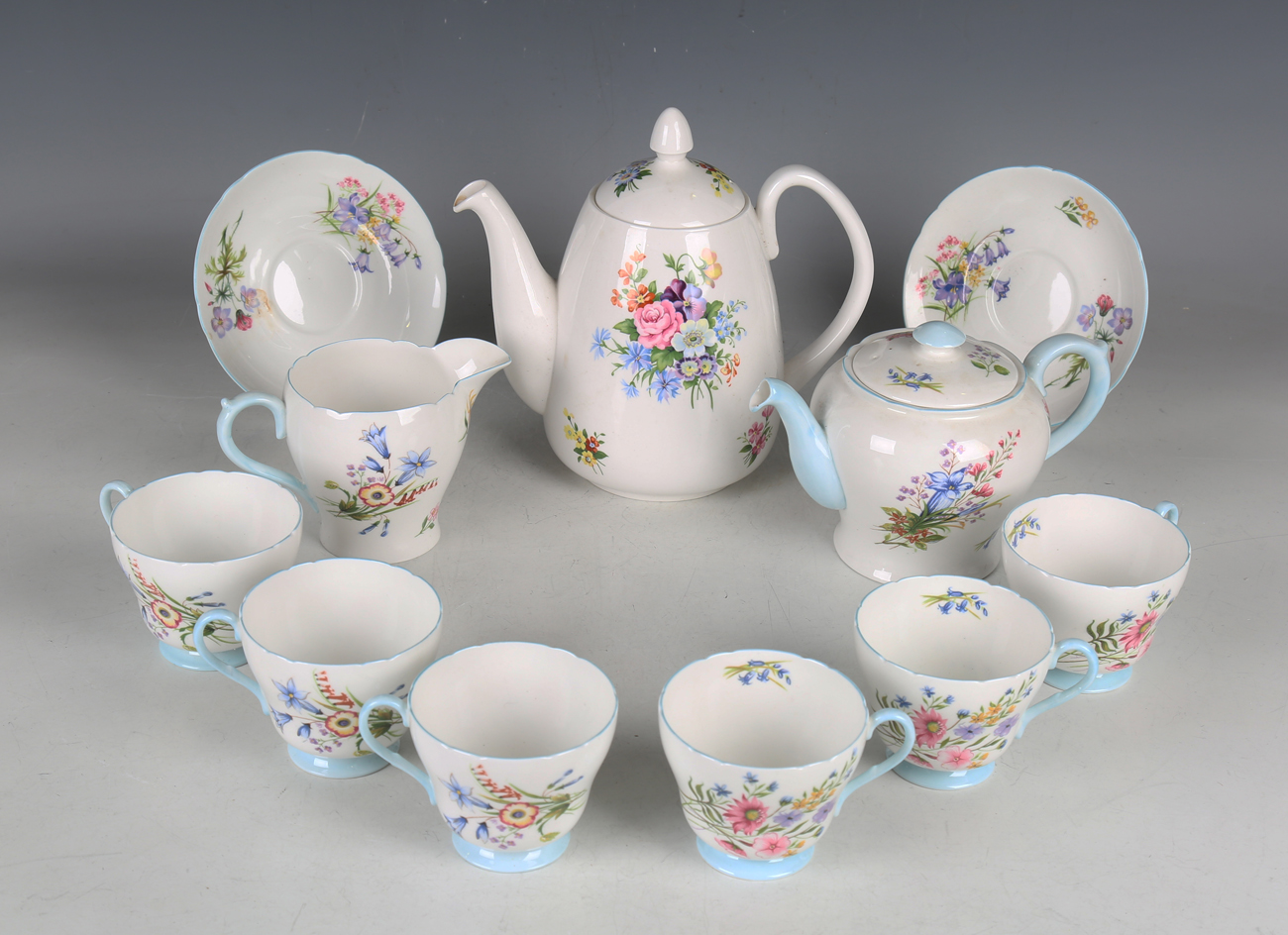 A Shelley Wild Flowers pattern part tea service, comprising cake plate, small teapot and cover, jug,