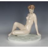 An Art Deco figure of a nude, 1940s, modelled by Elly Strobach, seated on a grassy mound, incised