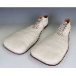 A pair of white leather clown's shoes, approx size 10, together with a mid-20th century travelling