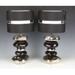 A pair of modern black and silver table lamps of stacked pebble form, height 50cm.Buyer’s Premium