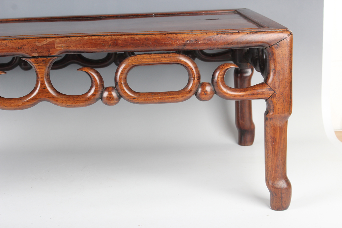 A Chinese hardwood low table, early 20th century, the rectangular panelled top above a carved and - Image 13 of 18