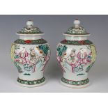 A pair of Chinese famille rose porcelain jars and covers, early 20th century, each baluster body