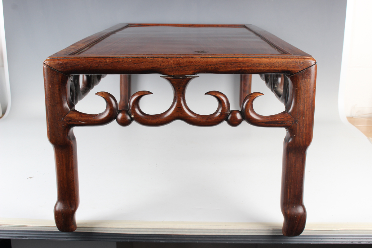 A Chinese hardwood low table, early 20th century, the rectangular panelled top above a carved and - Image 12 of 18