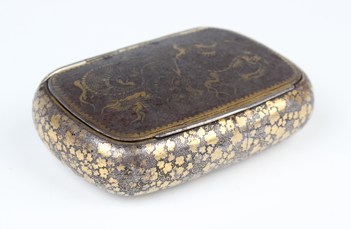 A Japanese damascened iron snuff box, Meiji period, of oblong form, the hinged lid finely worked