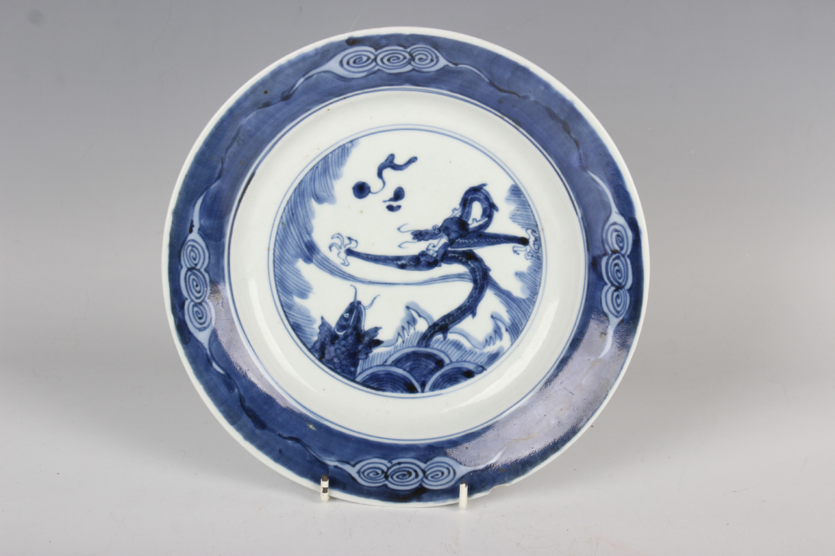 A Chinese blue and white porcelain circular dish, Kangxi period, the centre painted with a dragon