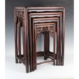 A Chinese hardwood quartetto nest of occasional tables, late Qing dynasty, each rectangular panelled