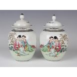 A pair of Chinese famille rose porcelain jars and covers, 20th century, each ovoid body painted with