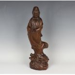 A Chinese carved hardwood figure of Guanyin, 20th century, modelled standing wearing a long robe