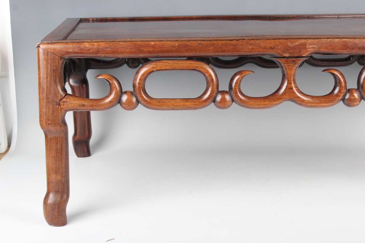 A Chinese hardwood low table, early 20th century, the rectangular panelled top above a carved and - Image 14 of 18