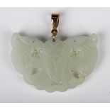 A Chinese pale celadon jade pendant, probably 20th century, carved and pierced in the form of a