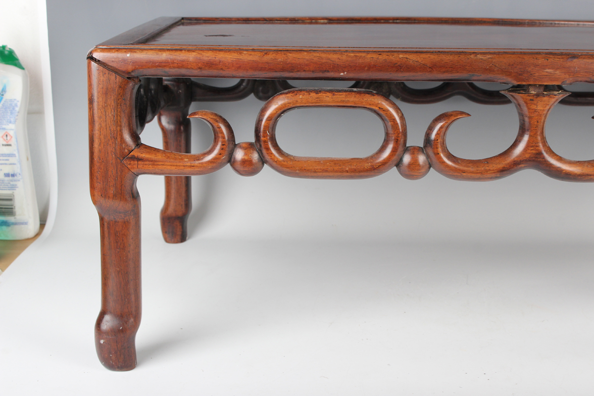 A Chinese hardwood low table, early 20th century, the rectangular panelled top above a carved and - Image 10 of 18