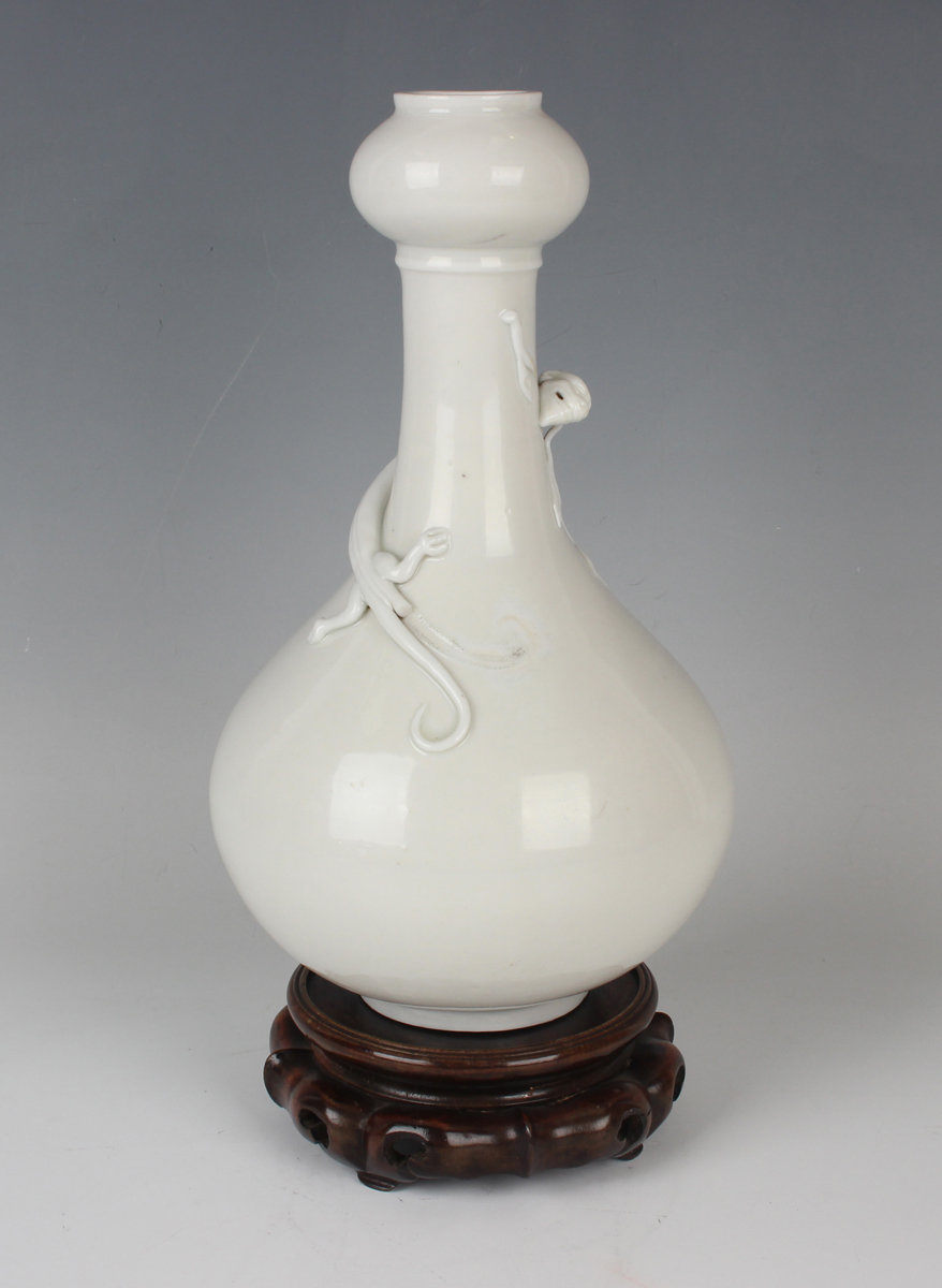 A Chinese blanc-de-Chine porcelain 'chilong' bottle vase, Qing dynasty, the low-bellied body beneath - Image 9 of 11