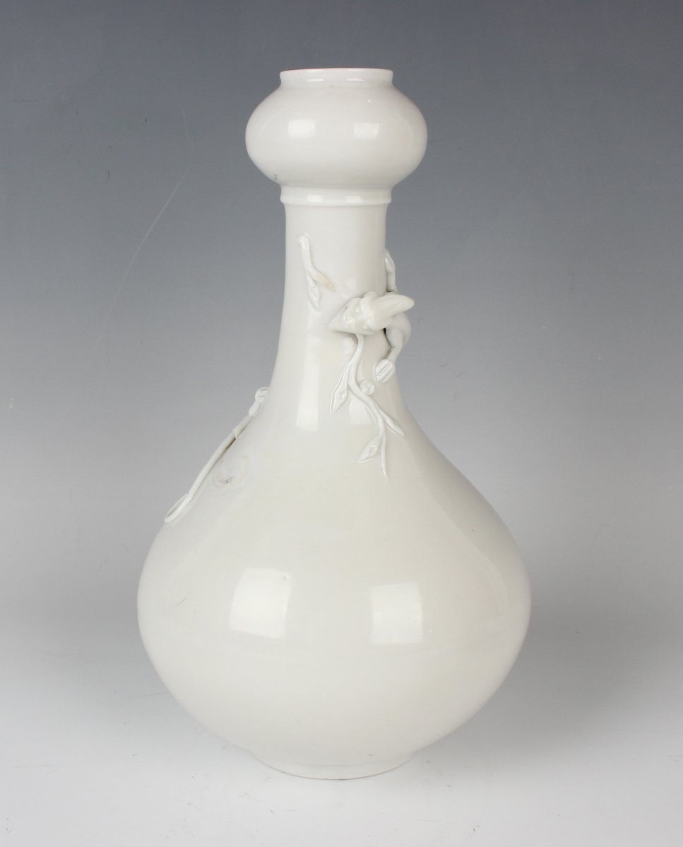 A Chinese blanc-de-Chine porcelain 'chilong' bottle vase, Qing dynasty, the low-bellied body beneath - Image 7 of 11