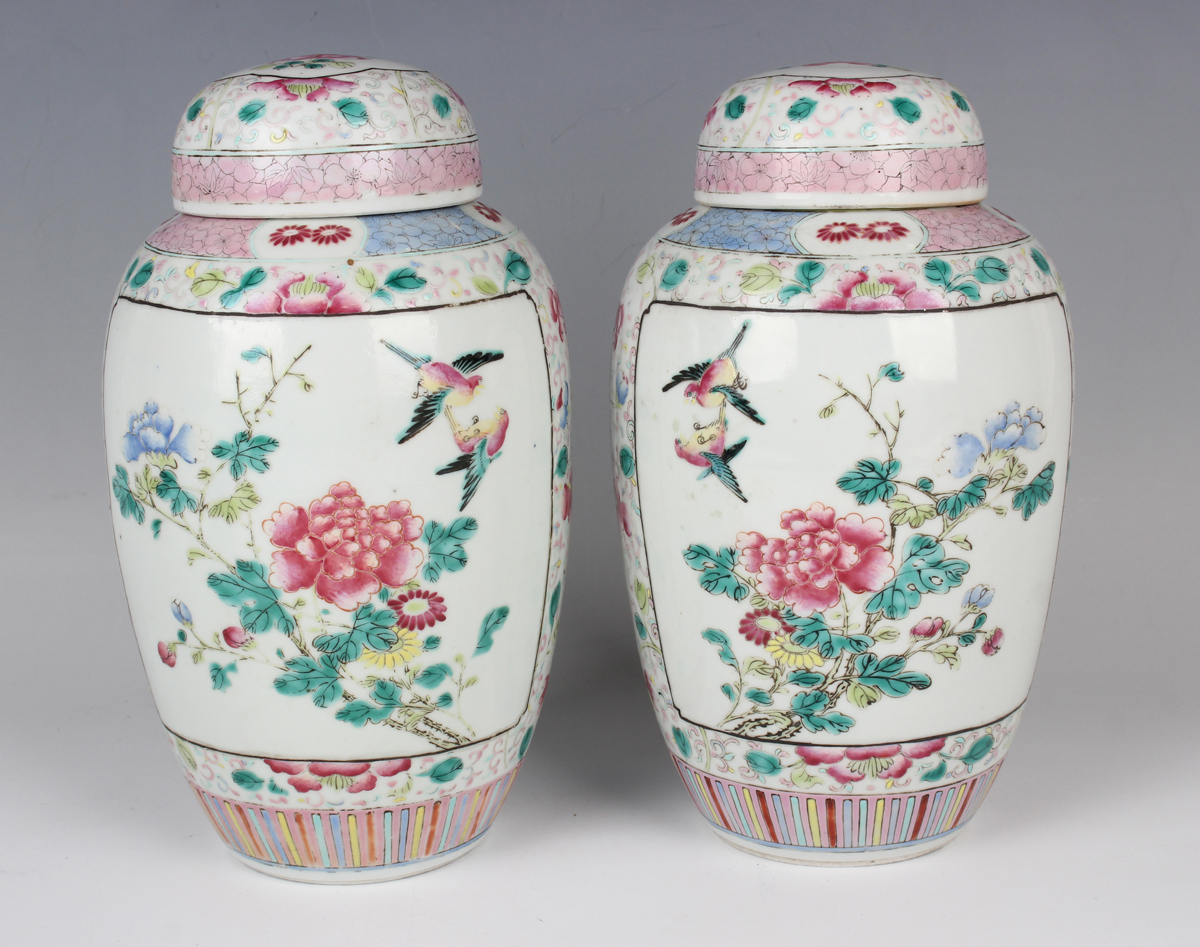 A pair of Chinese famille rose porcelain jars and domed covers, late Qing dynasty, each elongated