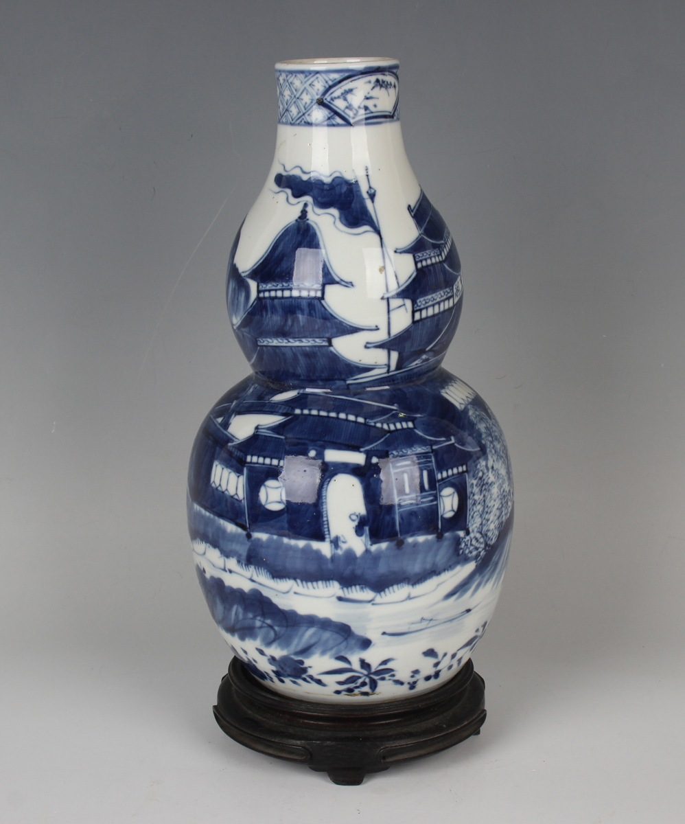 A Chinese blue and white porcelain double gourd shaped vase, mark of Kangxi but late 19th century,