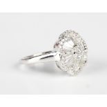 An 18ct white gold and diamond cluster ring in a flowerhead shaped design, mounted with circular and