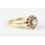 A gold and diamond cluster ring, claw set with the principal circular cut diamond to the centre,