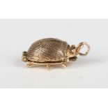 A 9ct gold pendant charm, designed as a beetle opening to reveal the four musicians of The