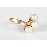 A gold ring, mounted with three cultured pearls in a twist design, detailed 'K14', weight 4.3g, ring