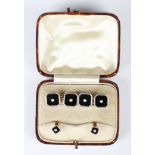 A pair of gold and platinum, black onyx and seed pearl cut cornered square dress cufflinks, each