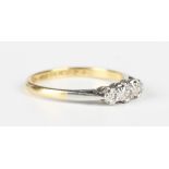 A gold, platinum and diamond three stone ring, mounted with a row of circular cut diamonds, detailed