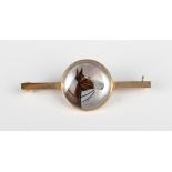 A gold and reverse painted intaglio crystal bar brooch, designed as a horse's head, weight 4.6g,