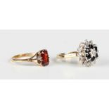 A gold ring, claw set with a rectangular cut garnet, detailed '18ct', weight 2.9g, ring size