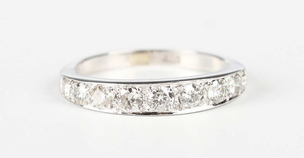 A white gold and diamond nine stone half-hoop eternity ring, mounted with a graduated row of - Image 5 of 5