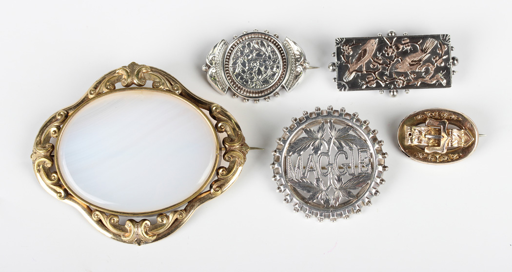 A group of mostly Victorian brooches, comprising an oval gold brooch with a central buckle and strap