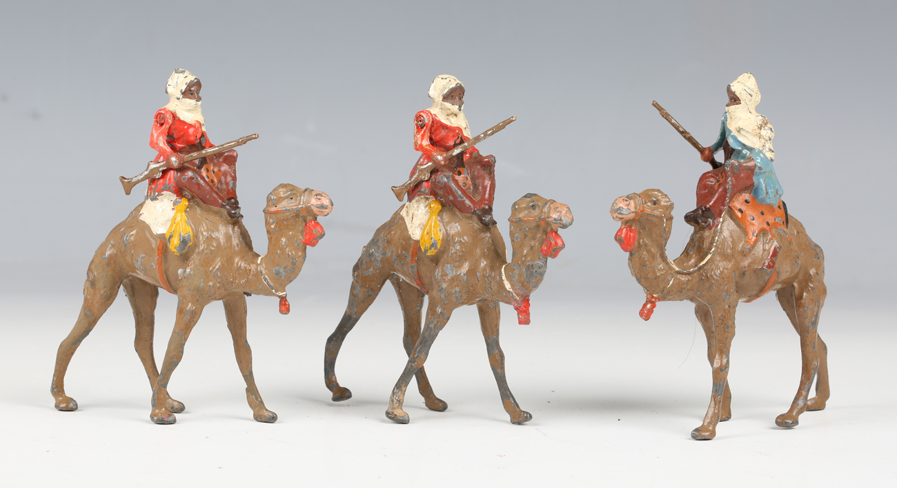 A set of three Britains Arabs of the Desert lead figures, each holding a jezail rifle and riding