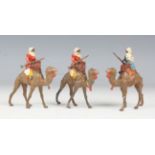 A set of three Britains Arabs of the Desert lead figures, each holding a jezail rifle and riding