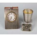 A George V silver mounted leather bedside timepiece with engine turned decoration, the folding