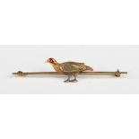 A three colour gold and enamelled bar brooch, designed as a gamebird, detailed '15ct 18ct', weight